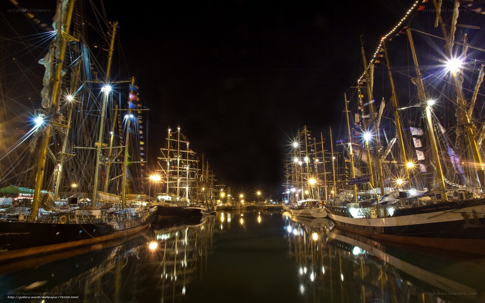 Nighttime harbor with tall ships