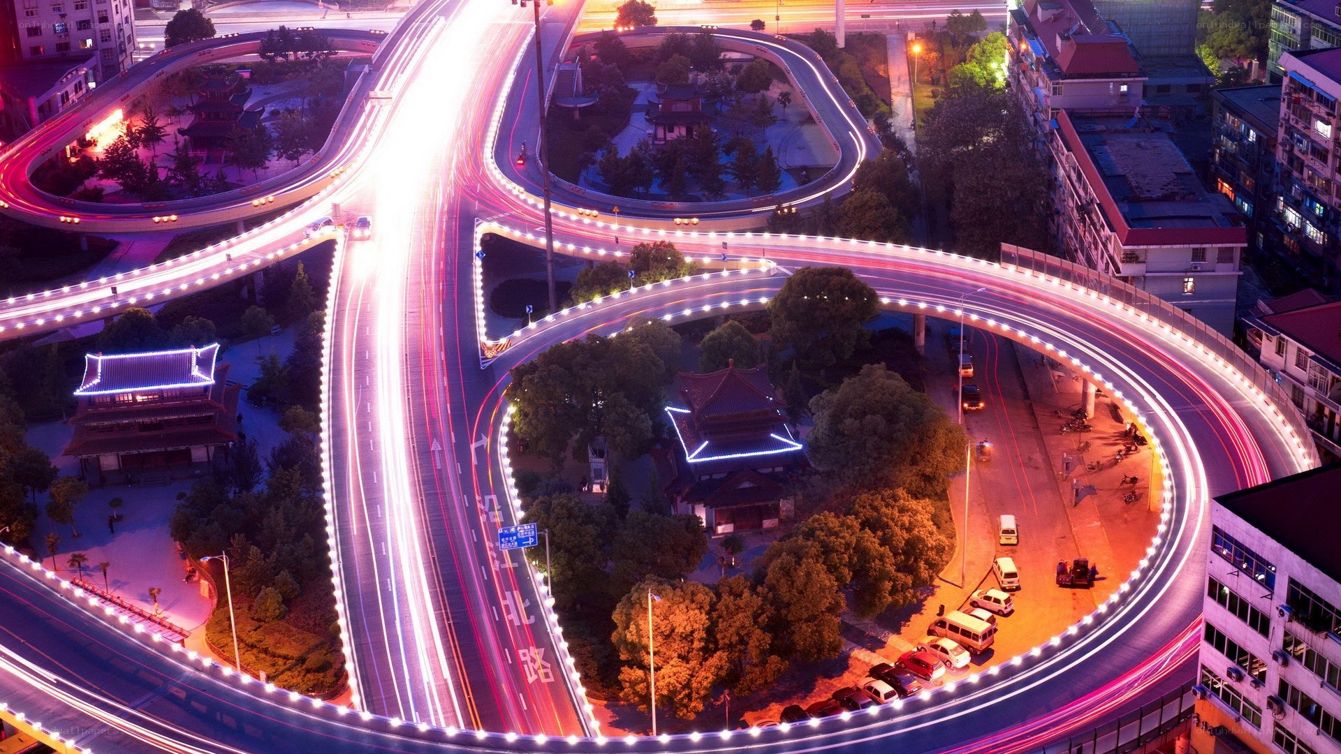 Nighttime highway interchange with light trails