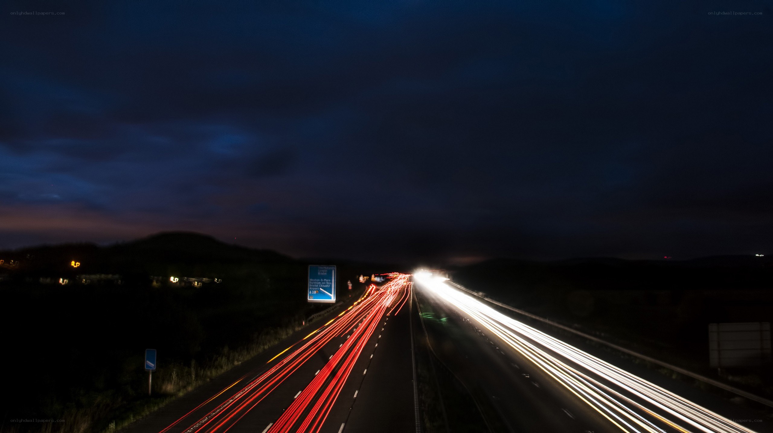 Nighttime highway traffic trails