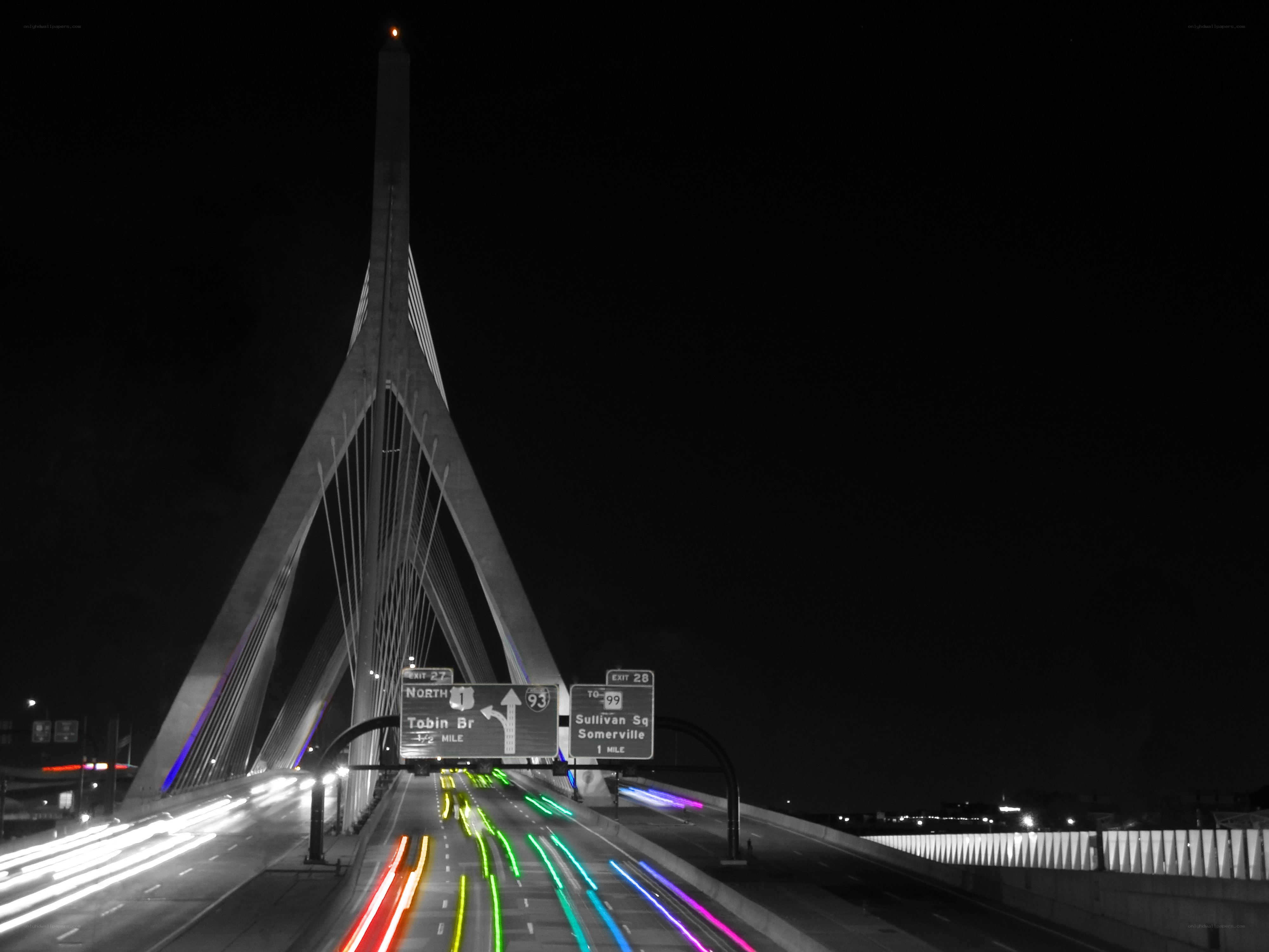 Nighttime highway with illuminated bridge