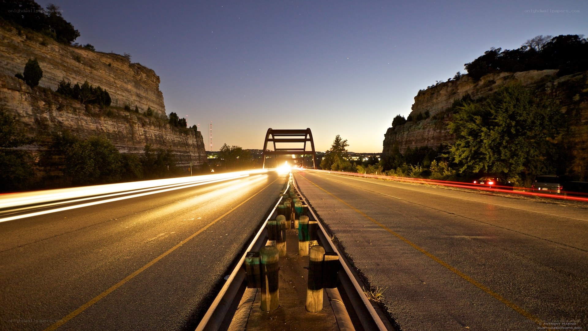 Nighttime highway with light trails