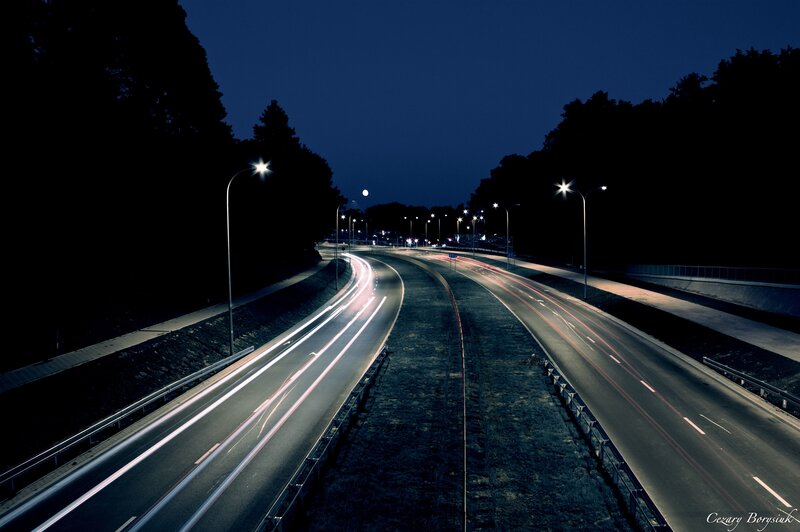 Nighttime highway with light trails