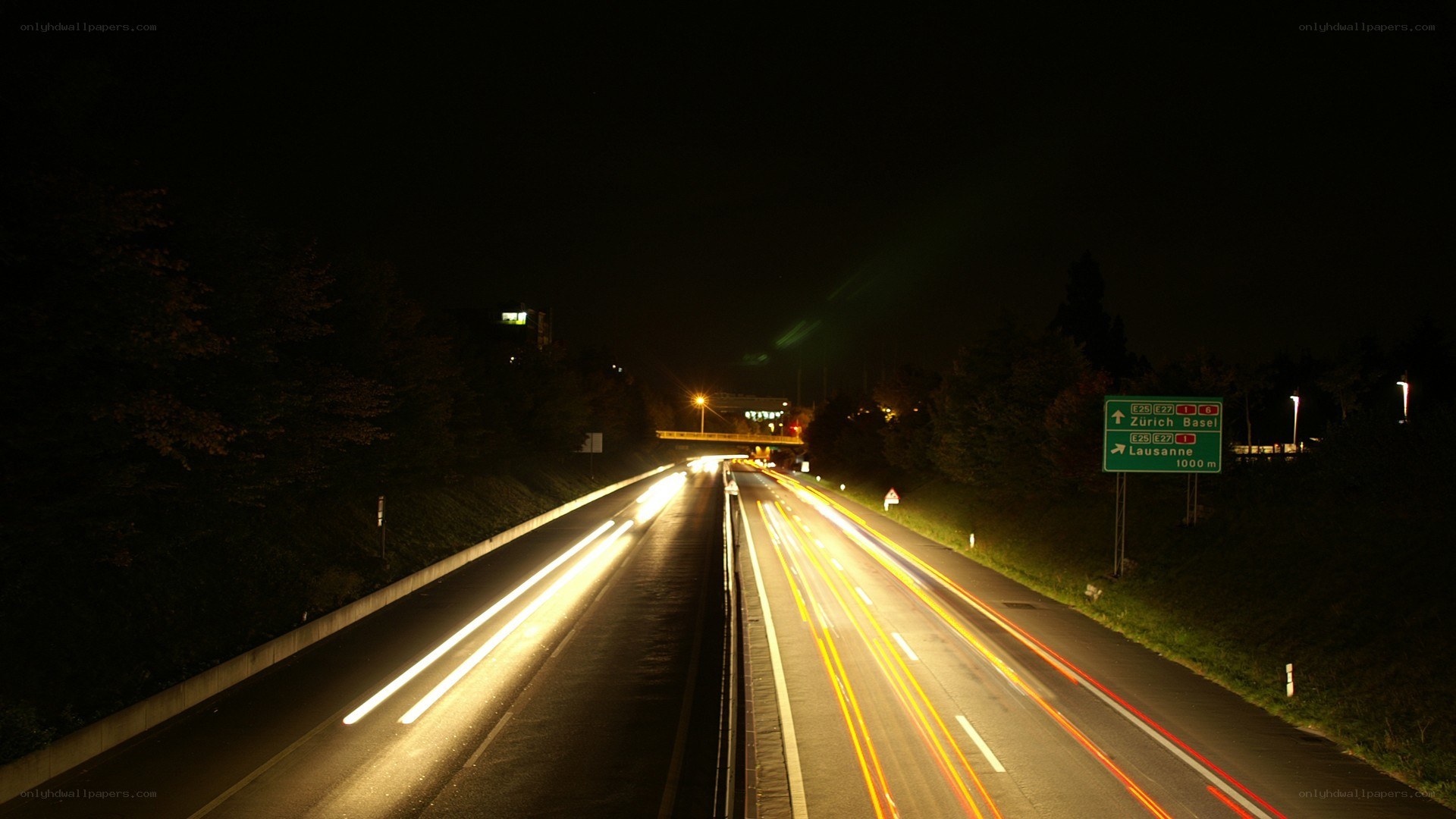 Nighttime highway with light trails