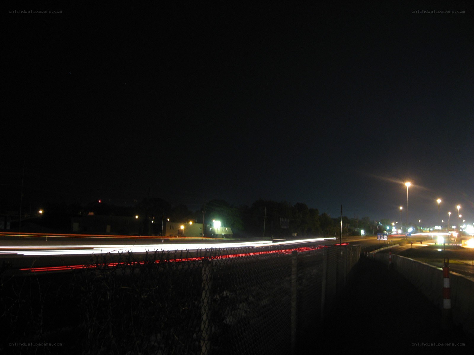 Nighttime highway with light trails