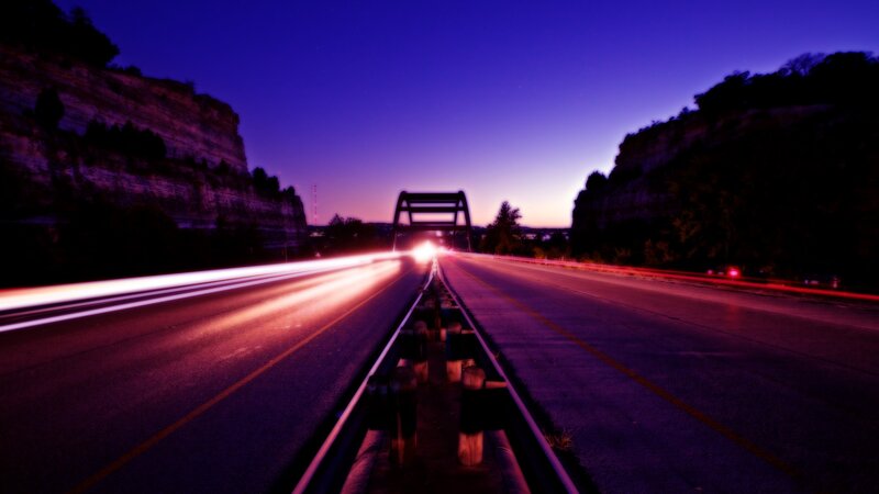Nighttime highway with light trails