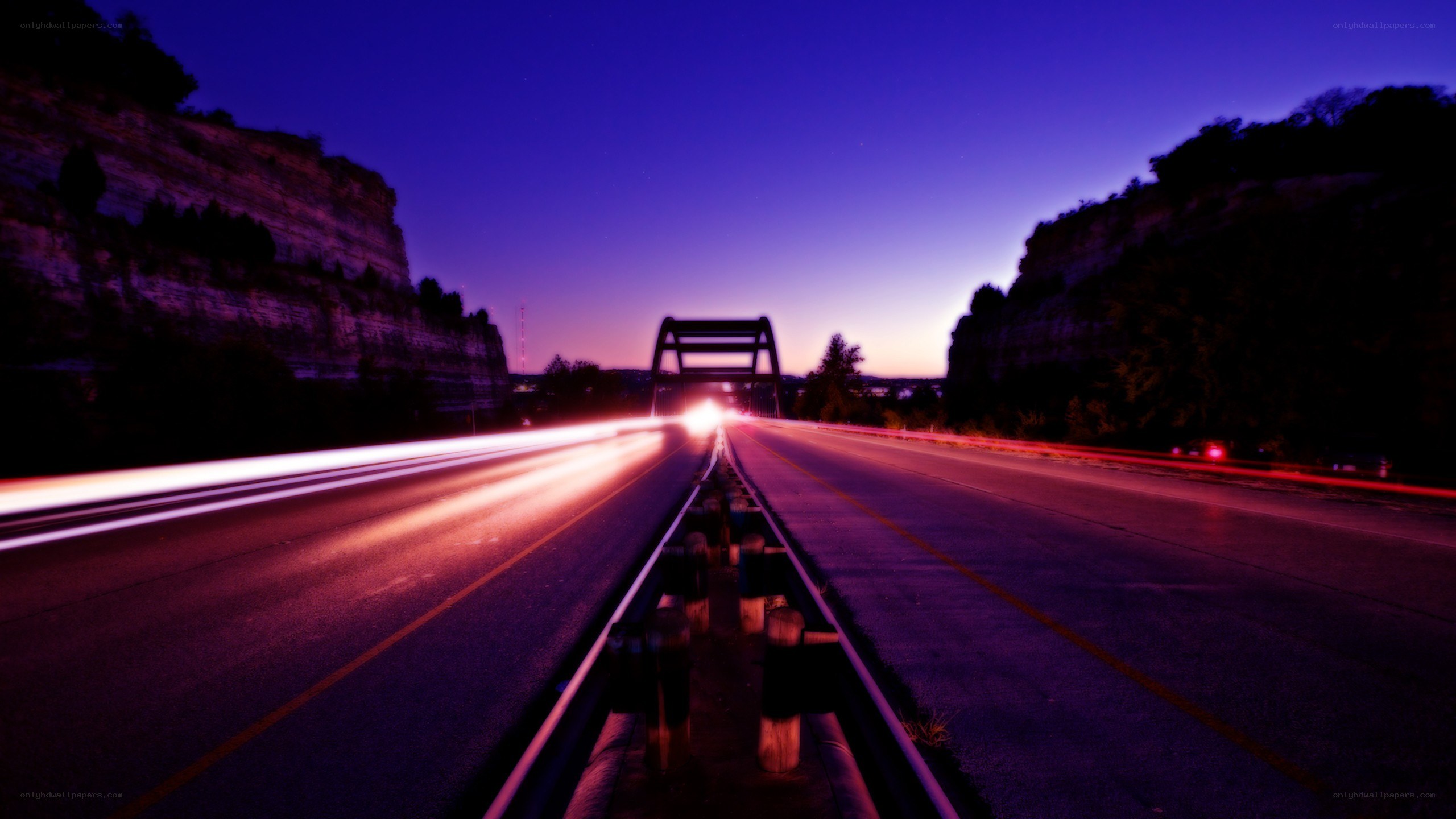 Nighttime highway with light trails