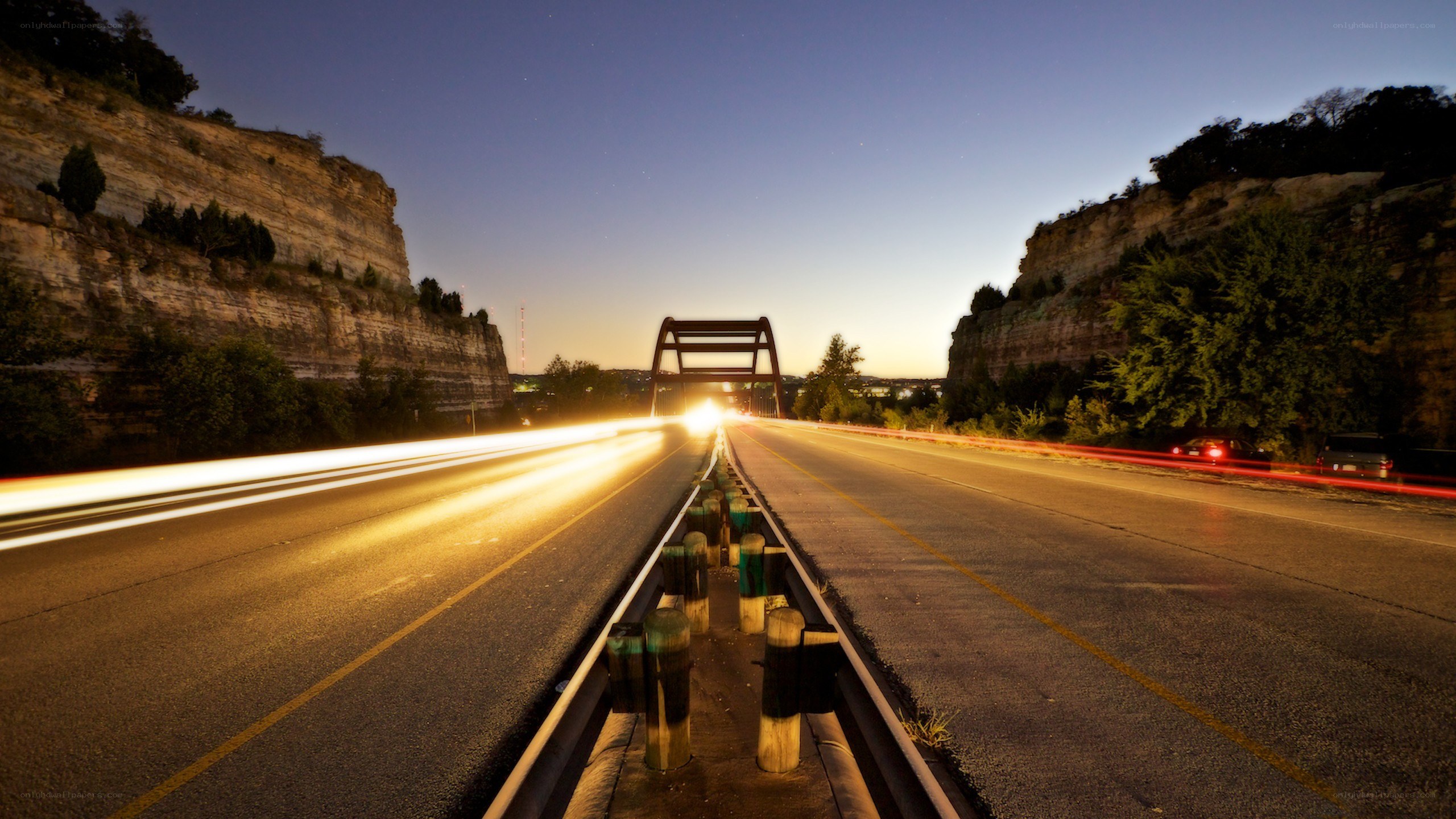 Nighttime highway with light trails
