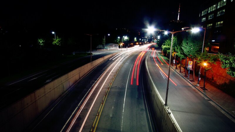 Nighttime highway with light trails