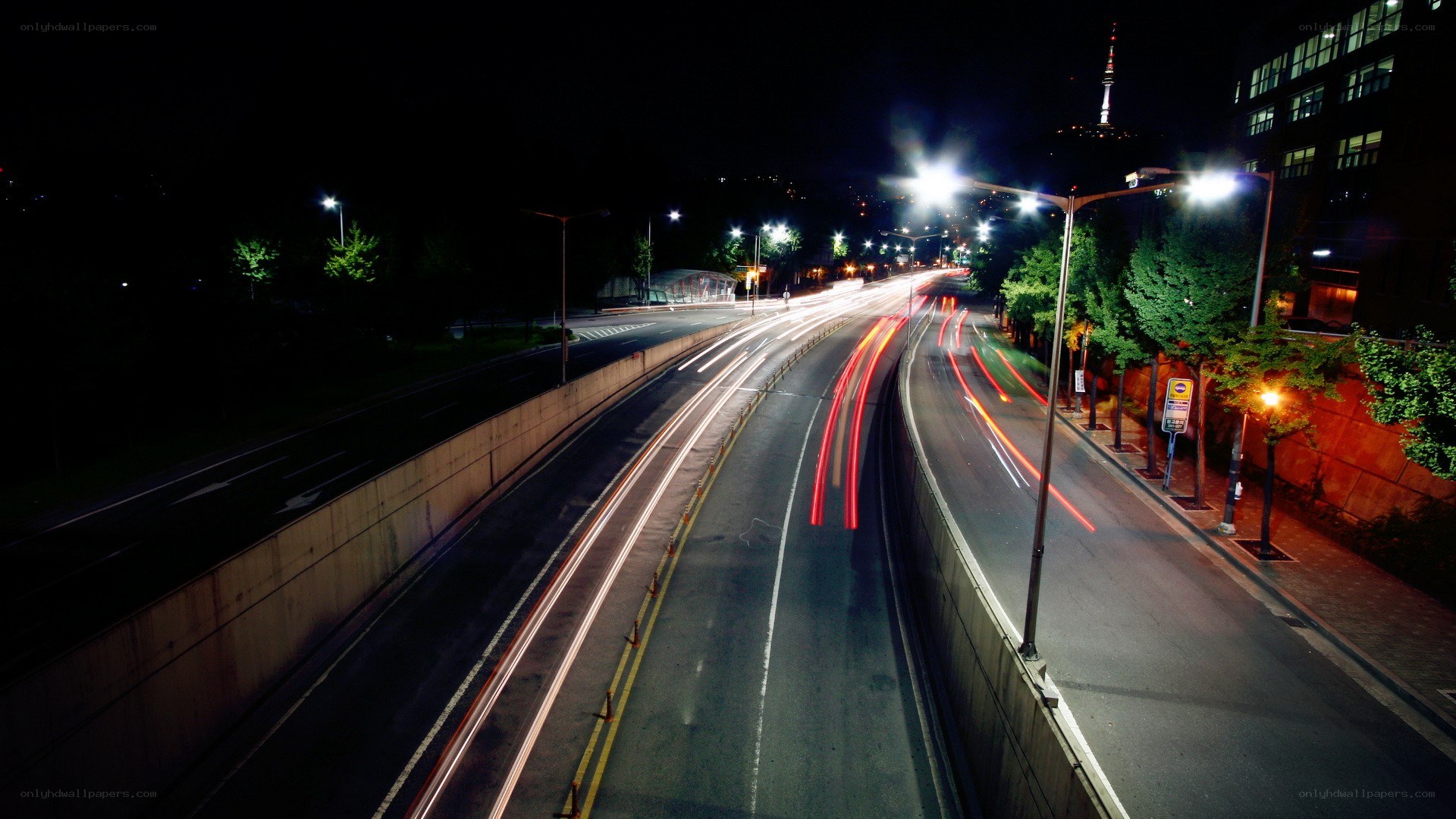 Nighttime highway with light trails
