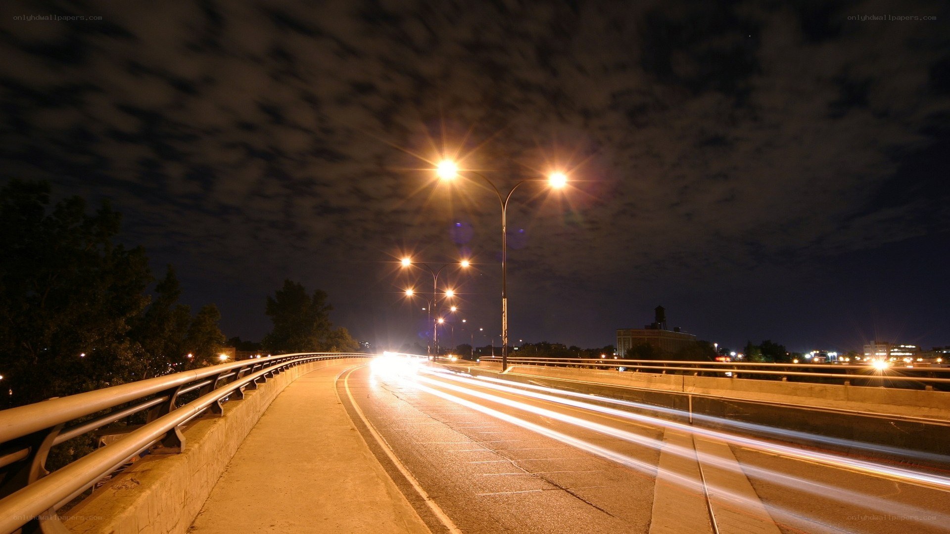 Nighttime highway with light trails