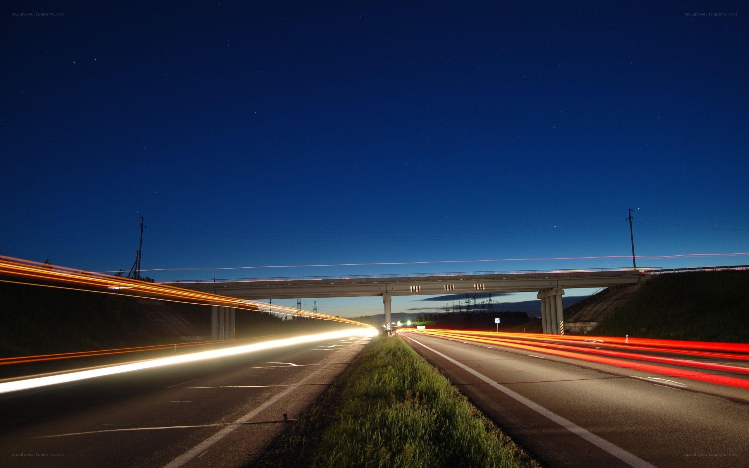 Nighttime highway with light trails