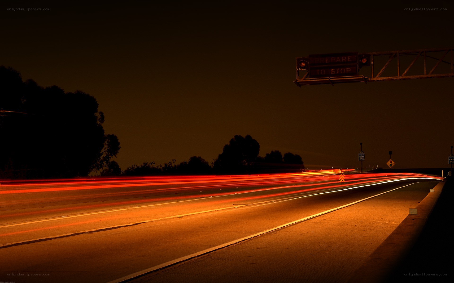 Nighttime highway with light trails