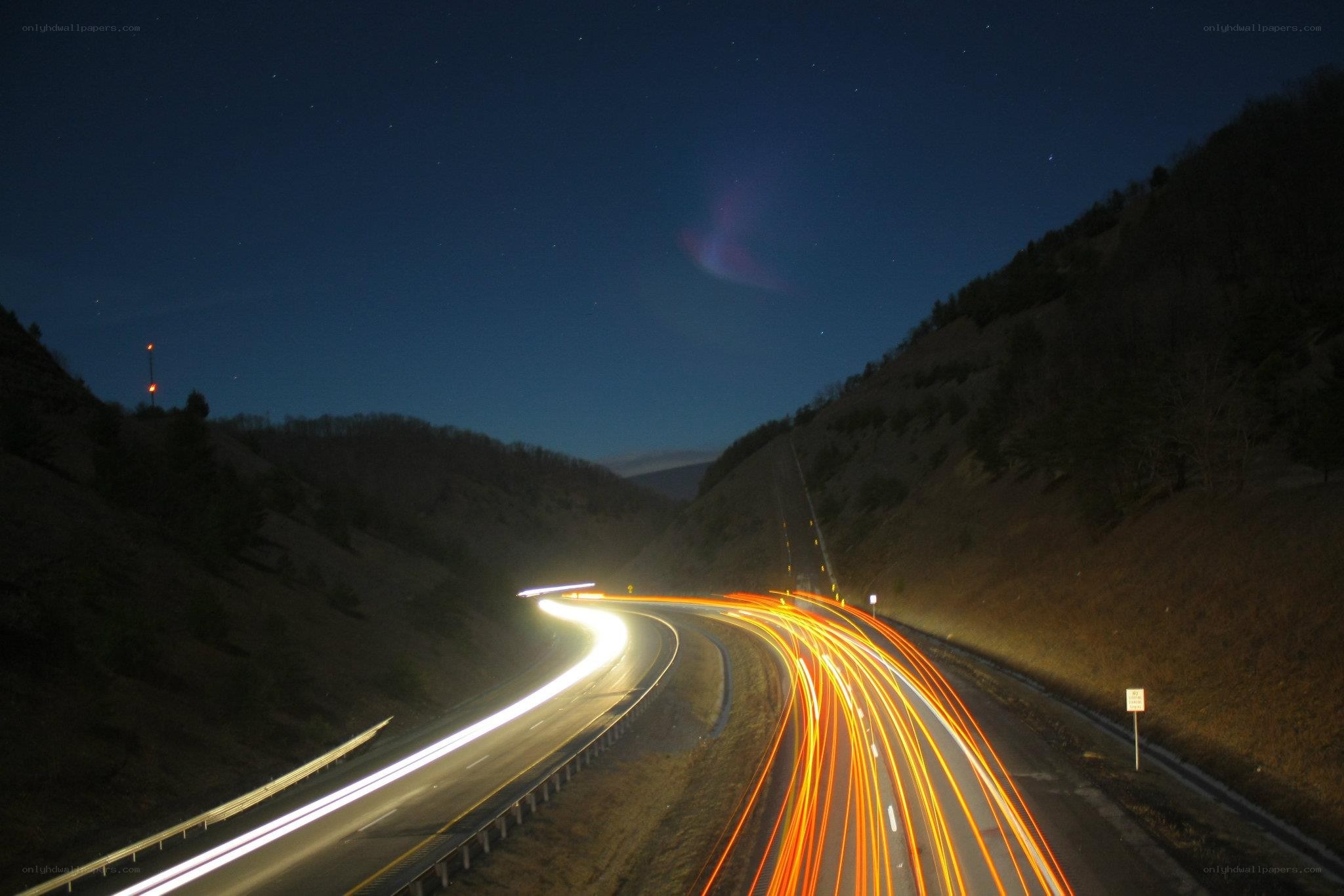 Nighttime highway with light trails