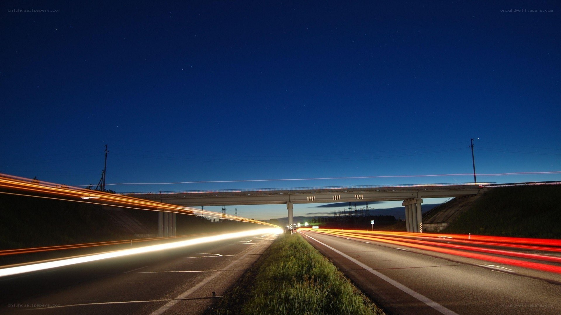 Nighttime highway with light trails