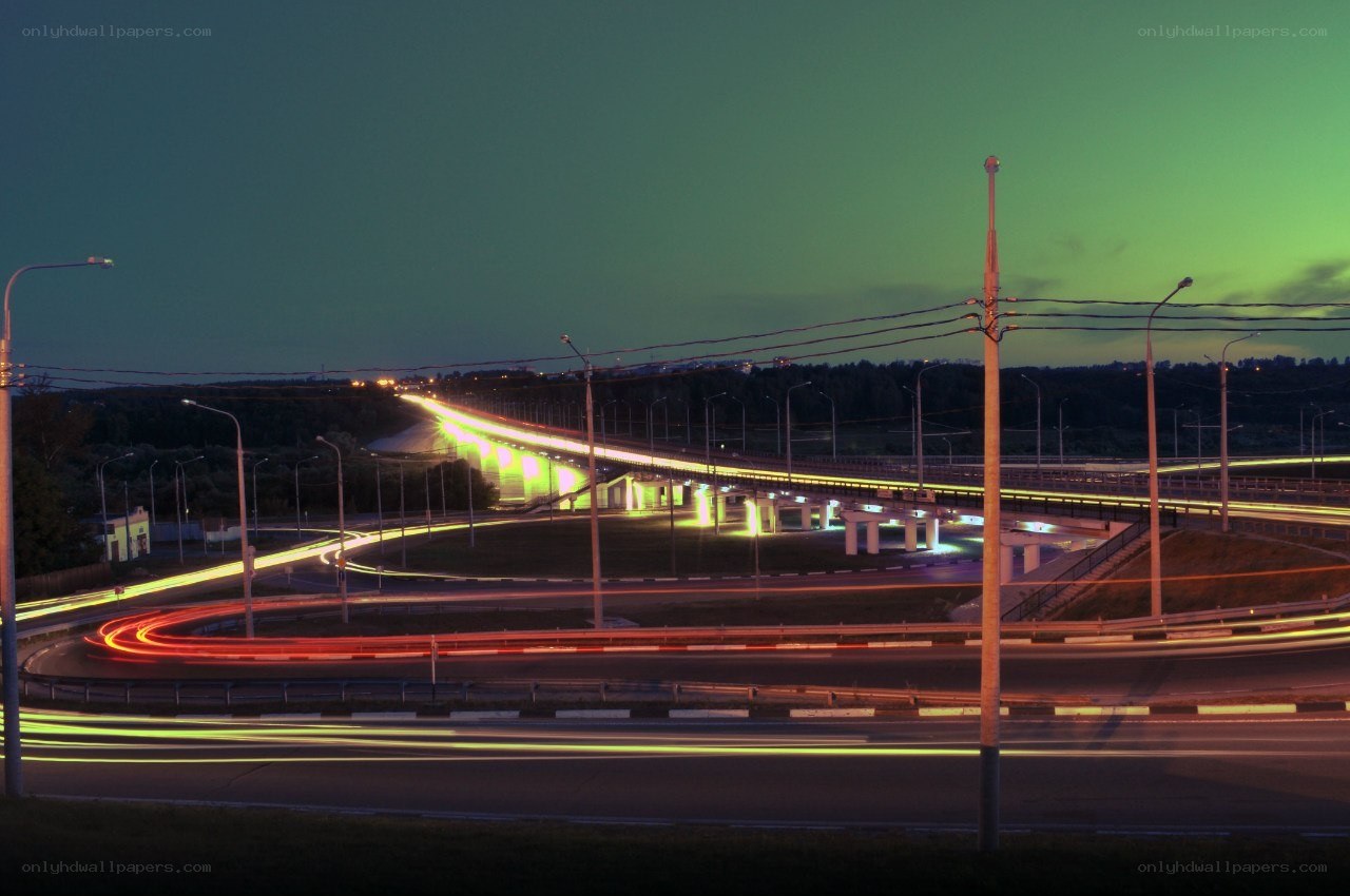 Nighttime highway with light trails