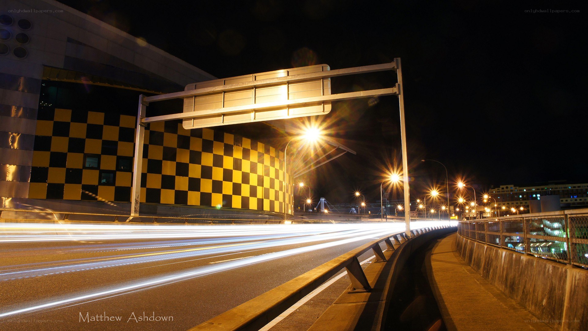 Nighttime highway with light trails