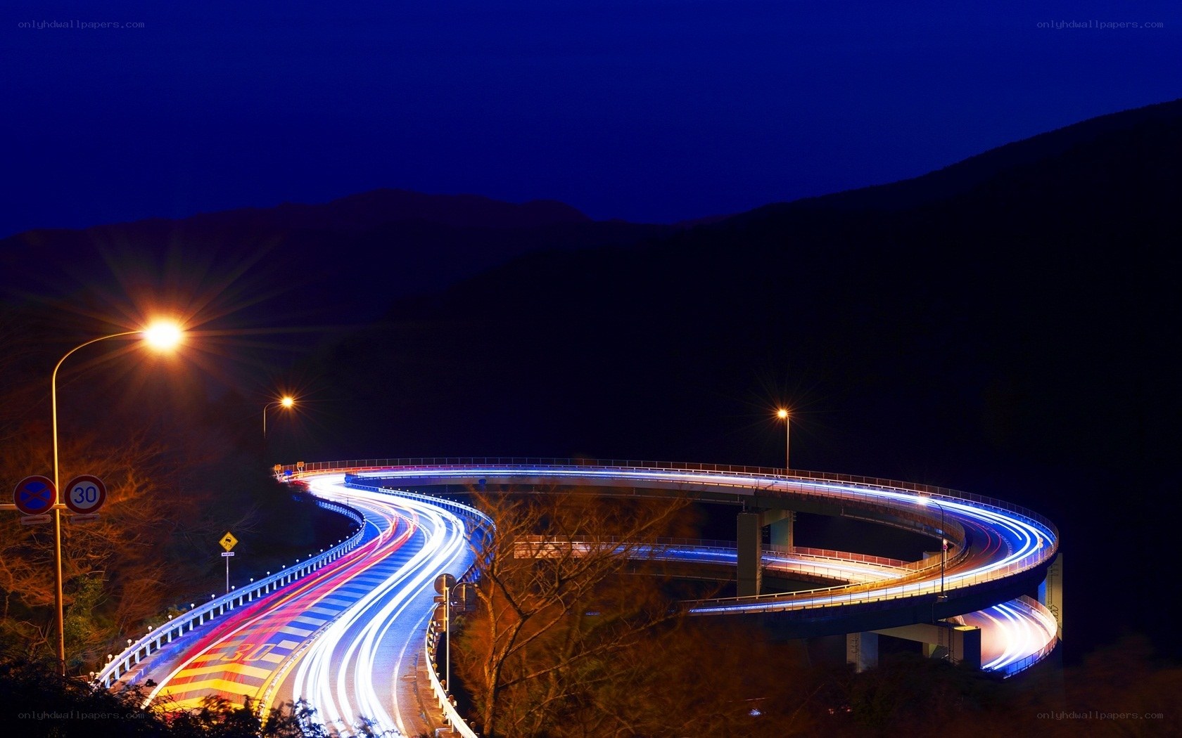 Nighttime highway with light trails