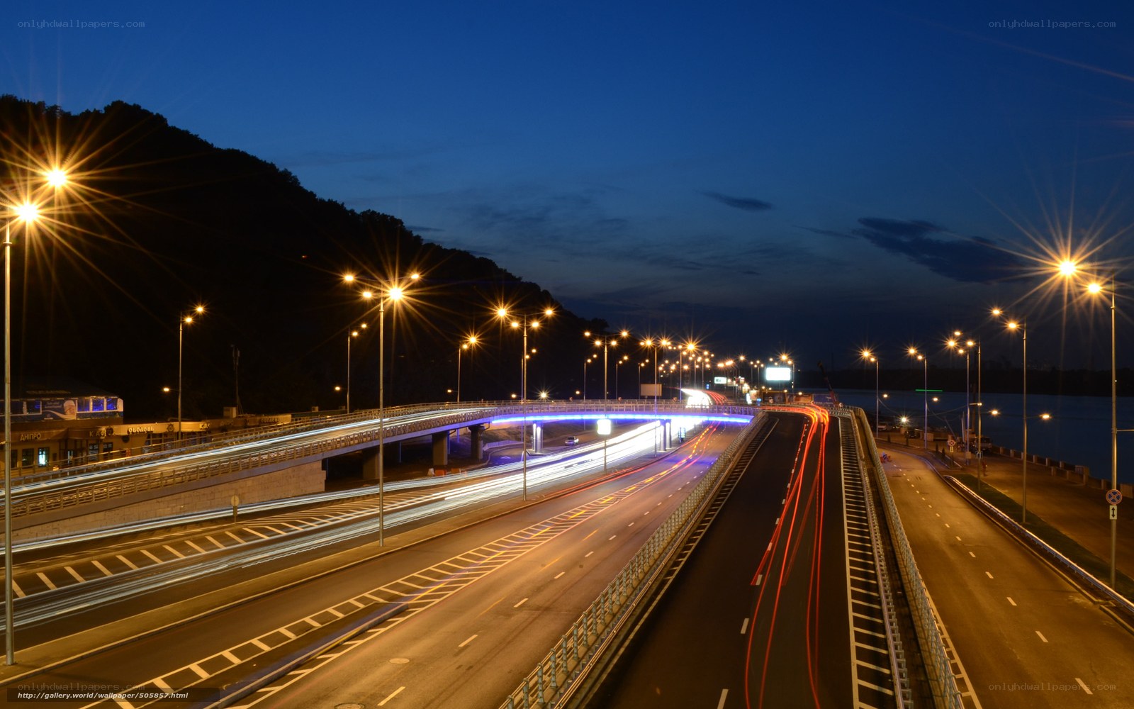 Nighttime highway with light trails