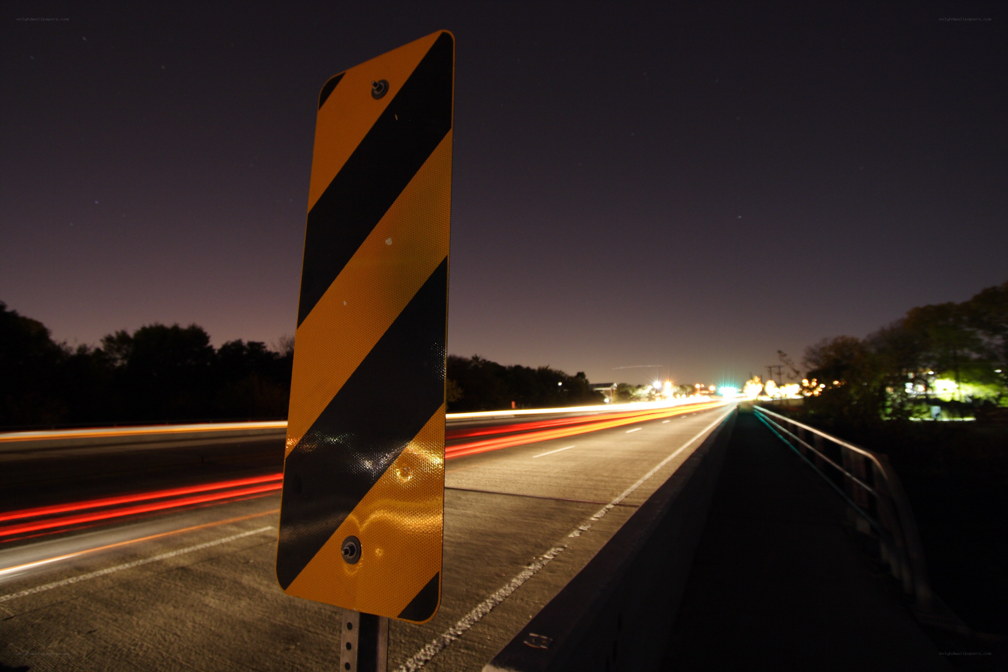 Nighttime highway with light trails
