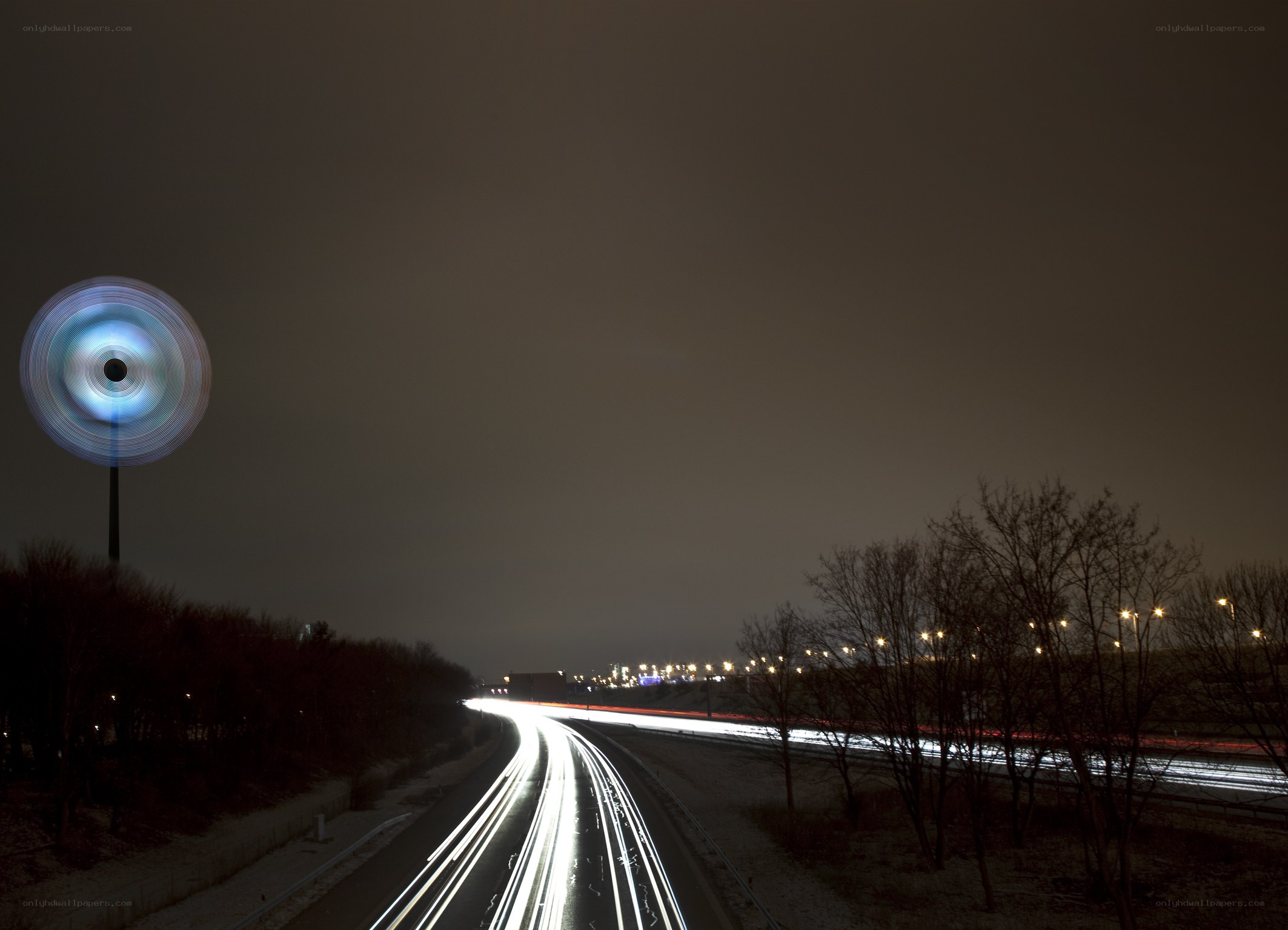 Nighttime highway with light trails