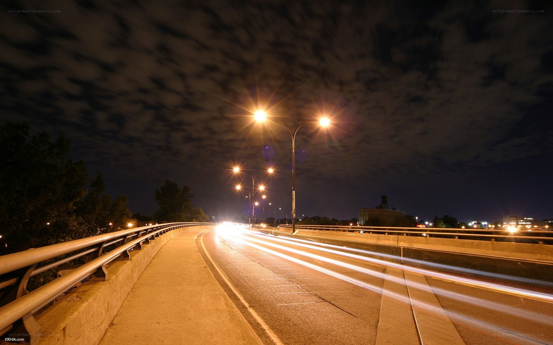 Nighttime highway with light trails