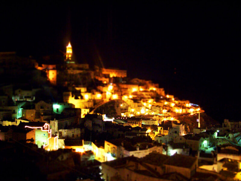 nighttime hillside town lights