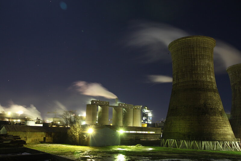 Nighttime industrial plant with cooling towers