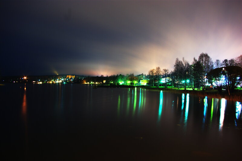 nighttime lake with city lights