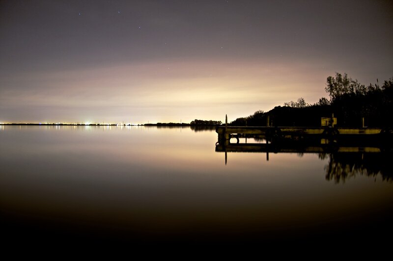 Nighttime lake with dock and stars