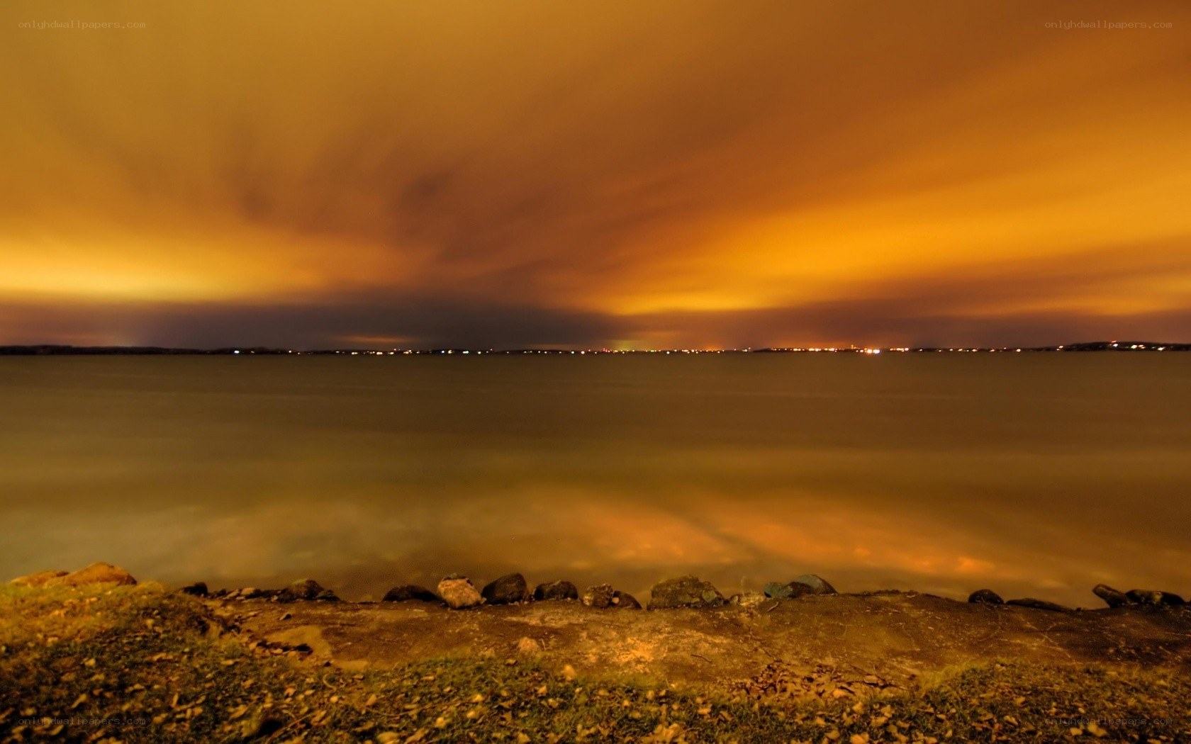 nighttime lake with orange sky