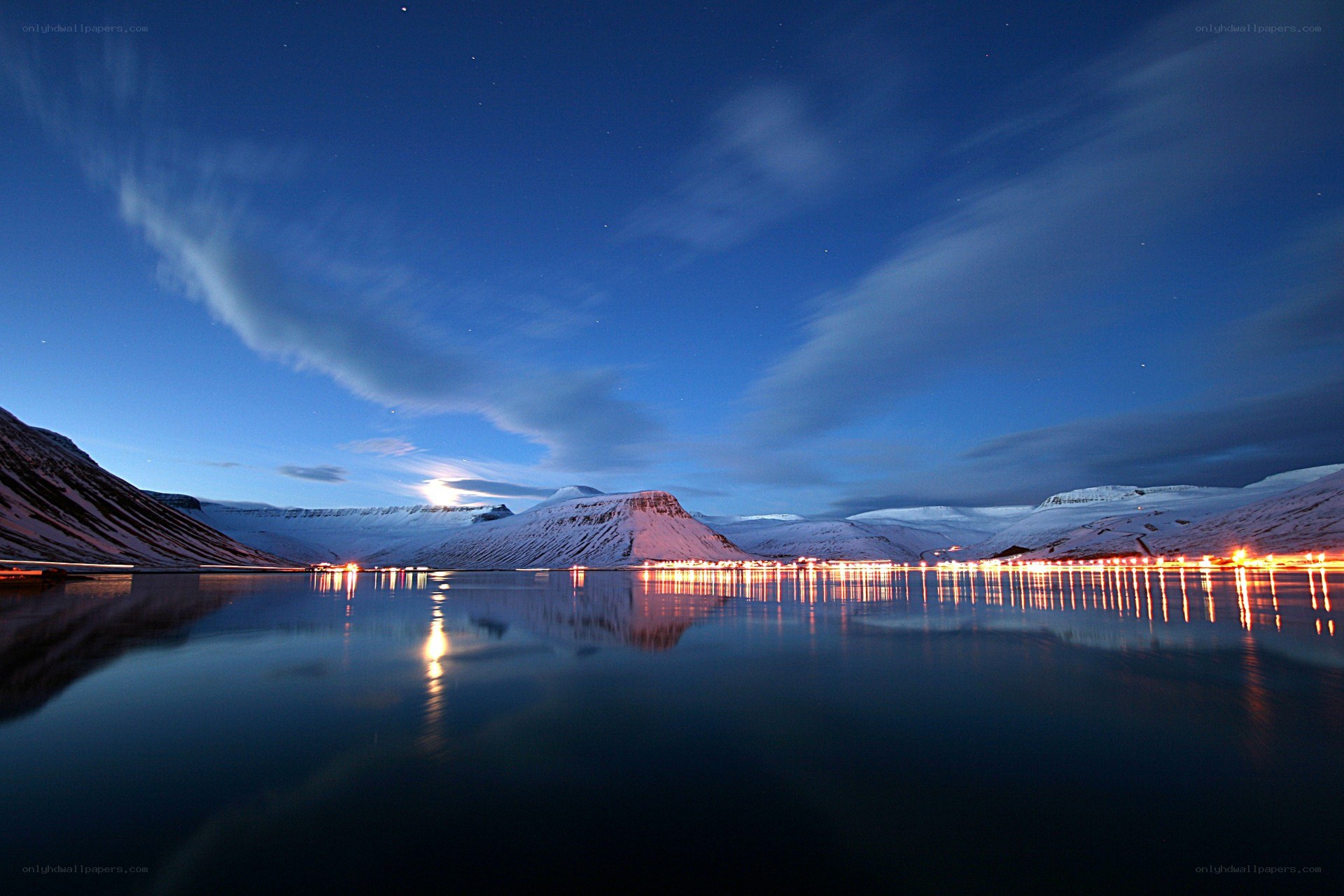 Nighttime landscape with snow-covered mountains