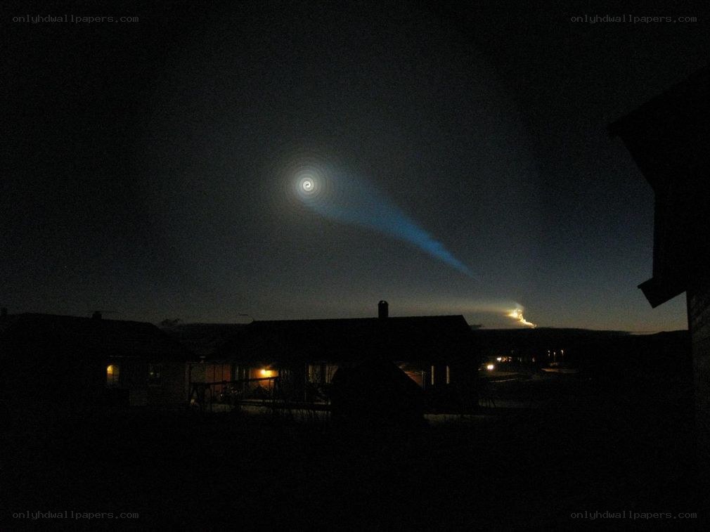 Nighttime light display over houses