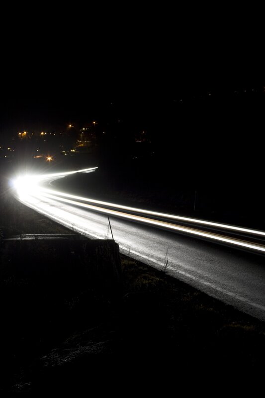 Nighttime light trails on a winding road