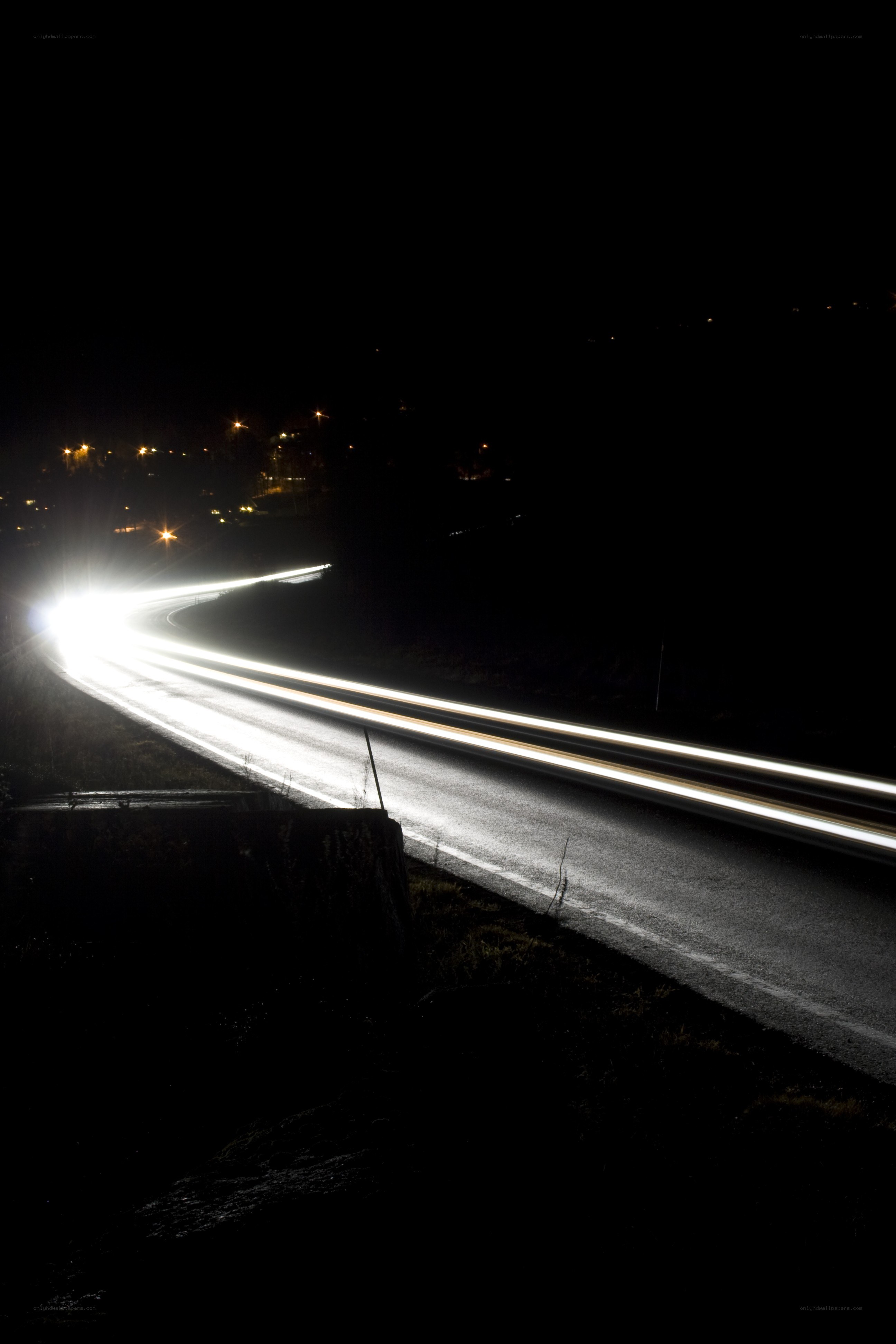 Nighttime light trails on a winding road