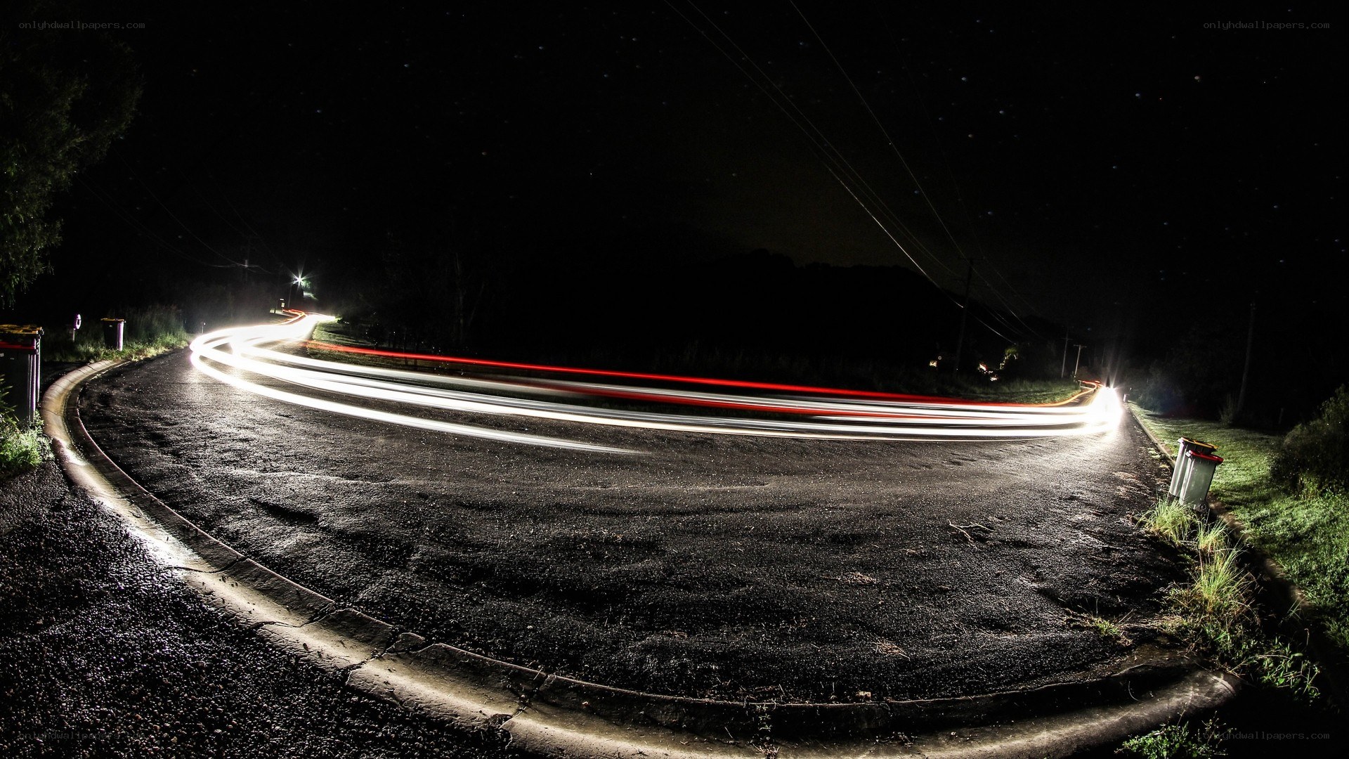 Nighttime light trails on a winding road