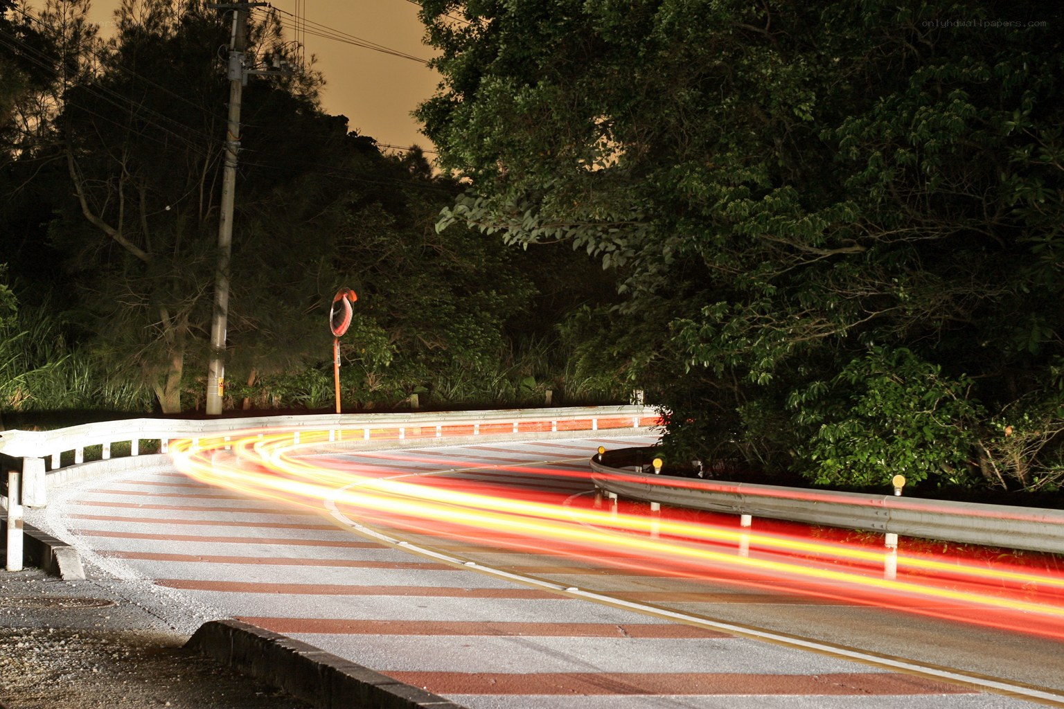 Nighttime light trails on a winding road