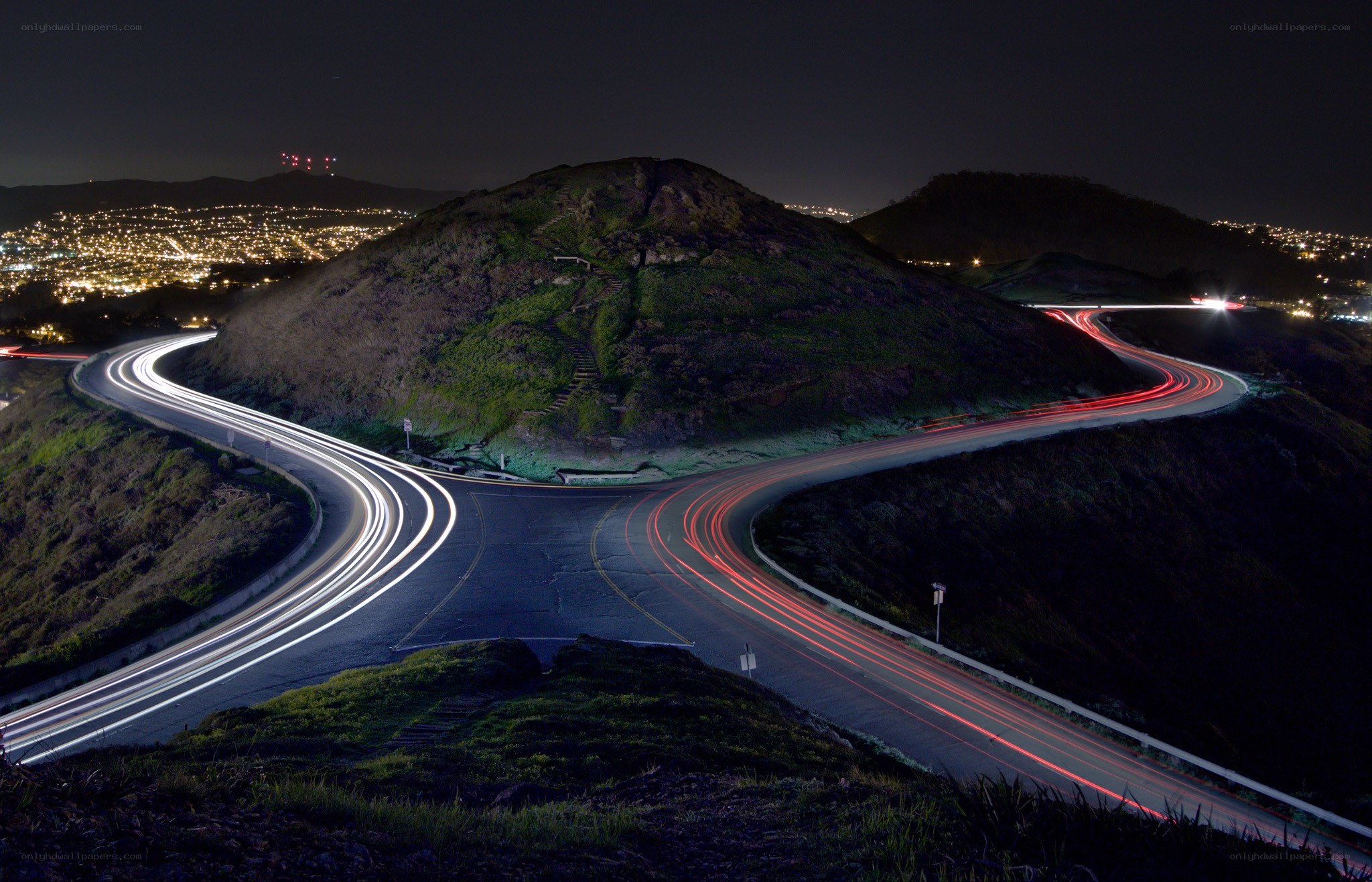 Nighttime light trails on winding road