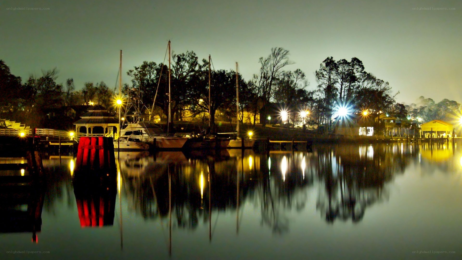 nighttime marina with boat reflections