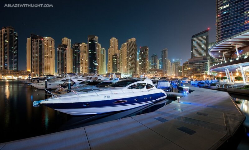 Nighttime marina with luxury yachts