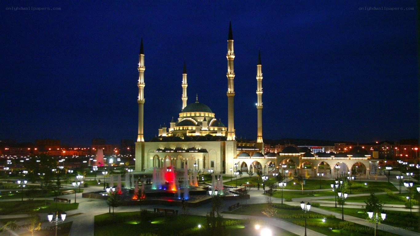 nighttime mosque with fountains