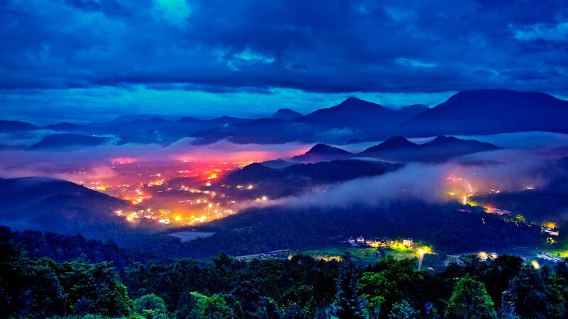 nighttime mountain valley with fog