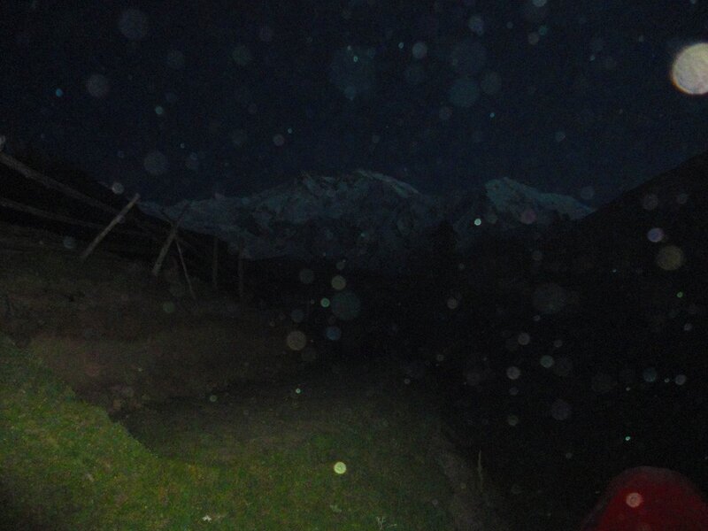 Nighttime mountain view with lens flare