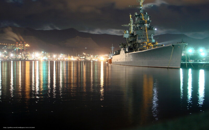 Nighttime naval ship in port