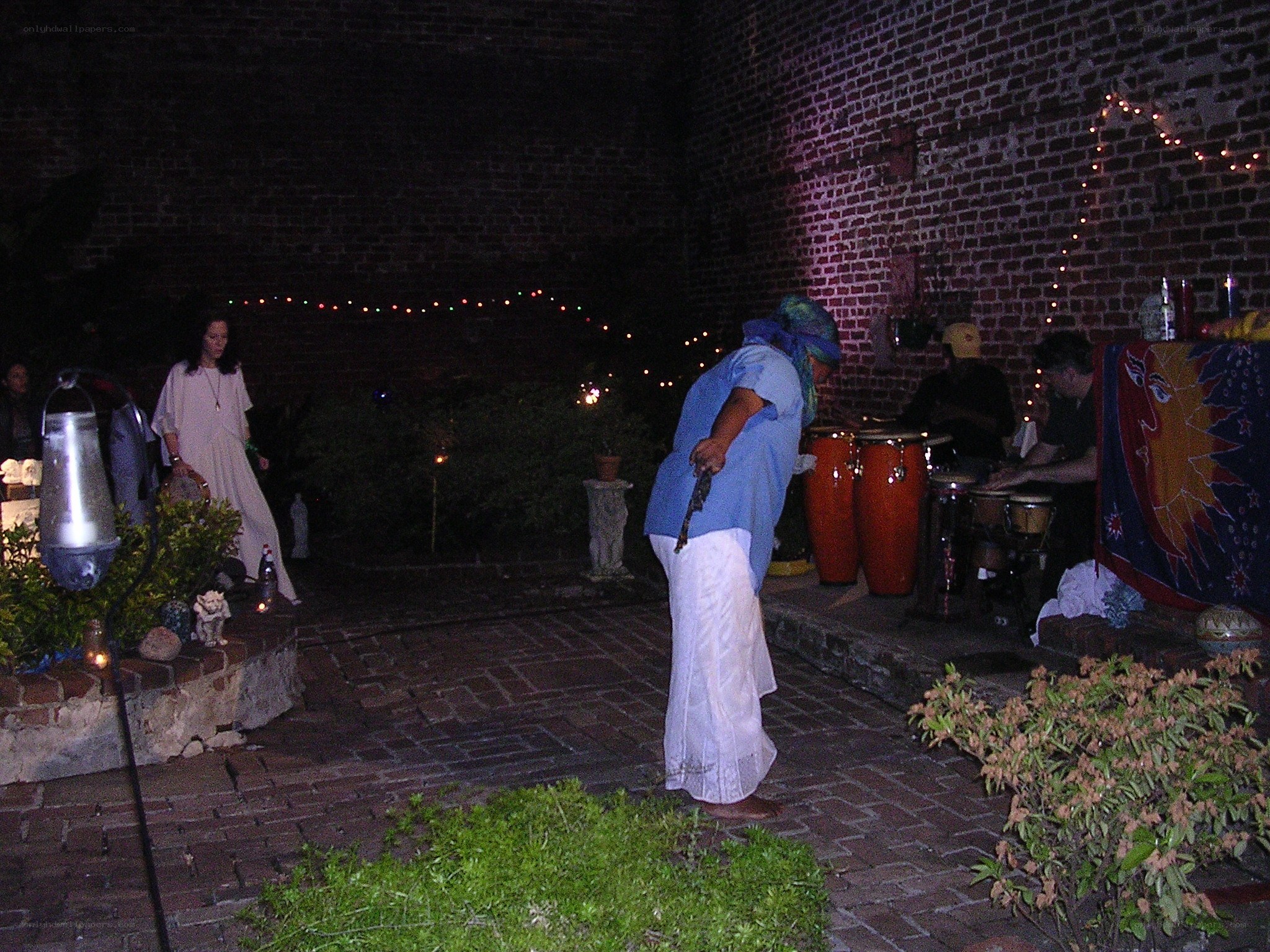 Nighttime outdoor gathering with musicians