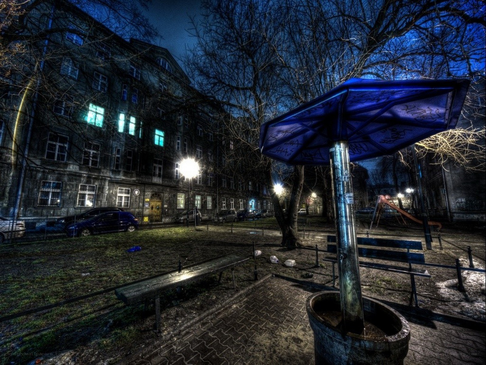 Nighttime park scene with blue umbrella
