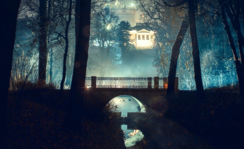 Nighttime park with bridge and house