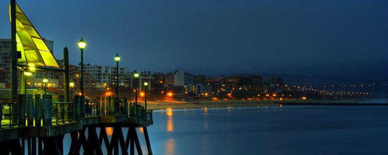 nighttime pier and beach scene