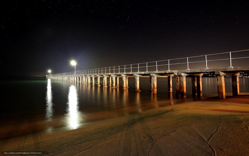 Nighttime pier under stars
