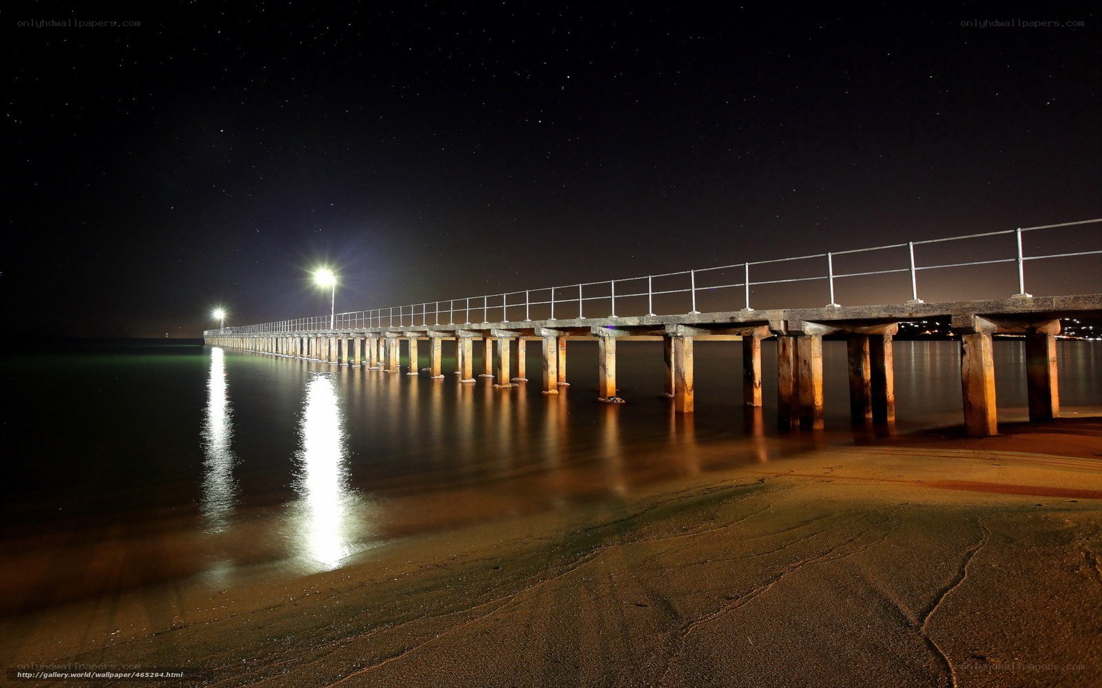 Nighttime pier under stars
