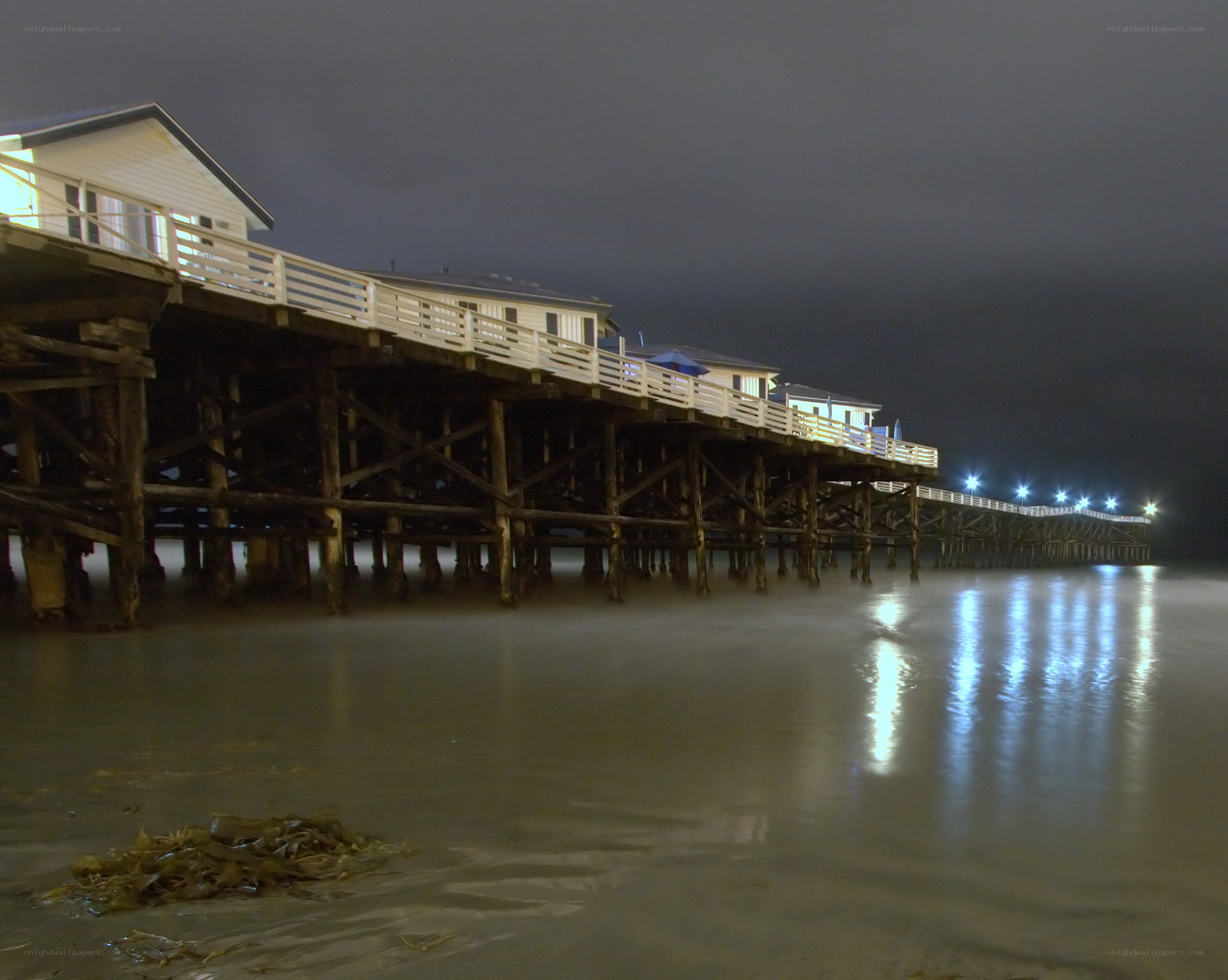 Nighttime pier with houses